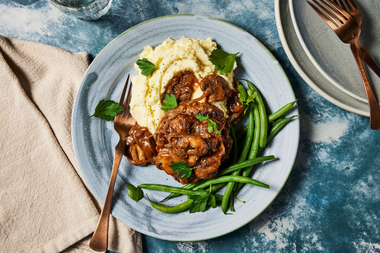Southern Living Hamburger Steak plated serving with mashed potatoes and green beans