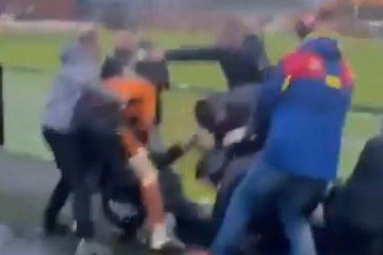 Huge fight breaks out at football match as players hit fans in the stands