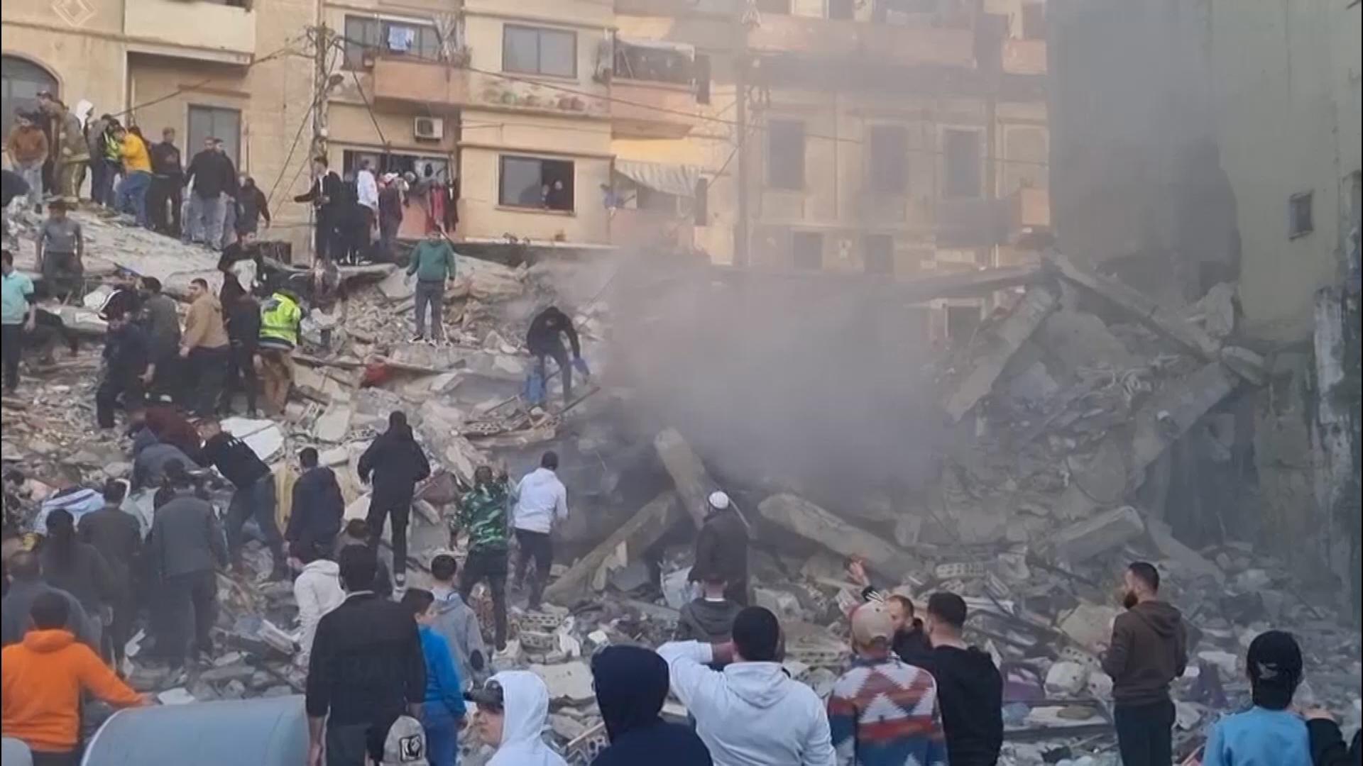 Rescuers search the rubble after building collapse in Tripoli