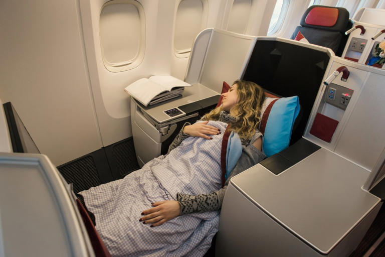 Woman travels first class, not ready for who ends up on her lap
