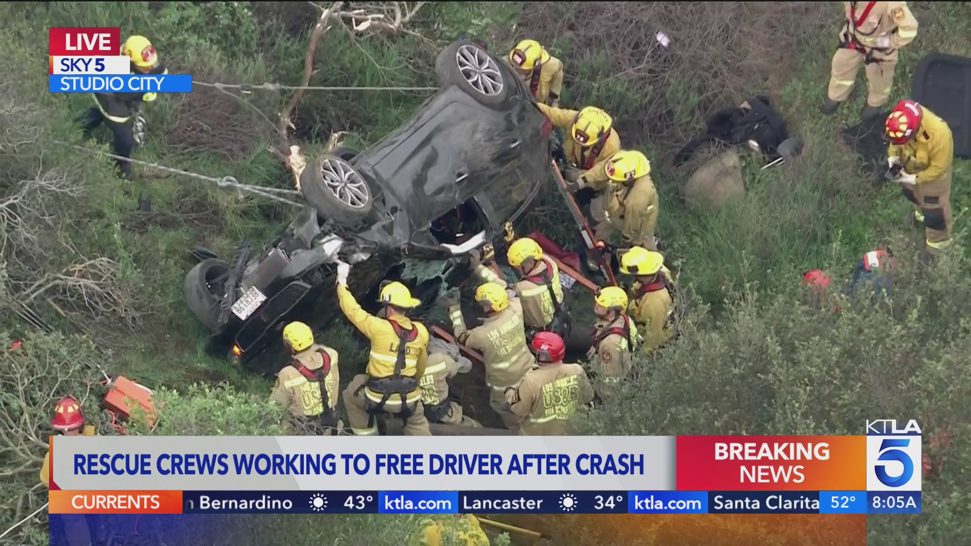 Rescue crews work to free driver after crash off Mulholland Drive