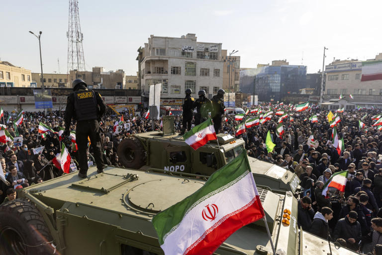 Security forces monitoring a pro-government rally earlier this month in Tehran.