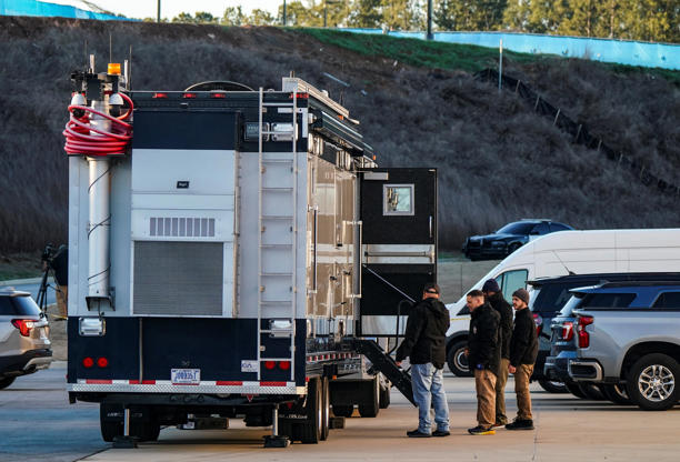 Law enforcement members are pictured on Jan. 28, 2026, outside the Fulton County Election Hub and Operation Center after the Federal Bureau of Investigation executed a search warrant there in relation to the 2020 election.