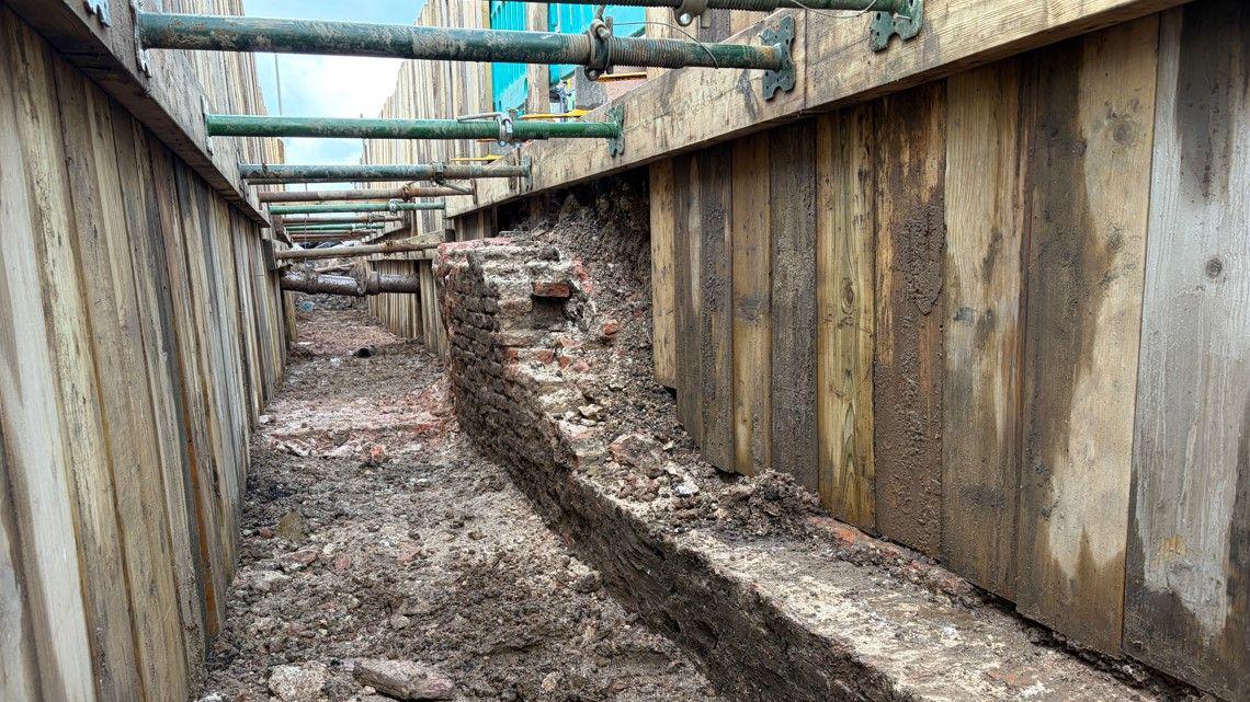 Glimpse of city's past as medieval wall uncovered