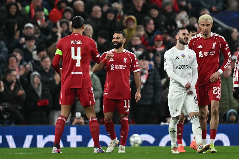 Liverpool's Egyptian striker #11 Mohamed Salah celebrates scoring the team's third goal with Liverpool's Dutch defender #04 Virgil van Dijk during the UEFA Champions League football match between Liverpool and Qarabag at Anfield in Liverpool, north west England on January 28, 2026. (Photo by Paul ELLIS / AFP via Getty Images)