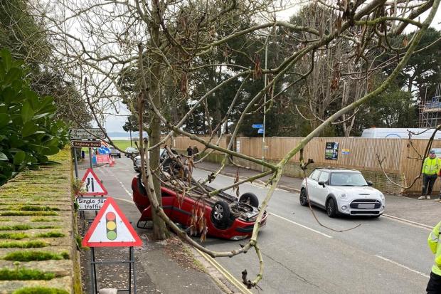 Occupants escape injuries after car ends up on roof in crash