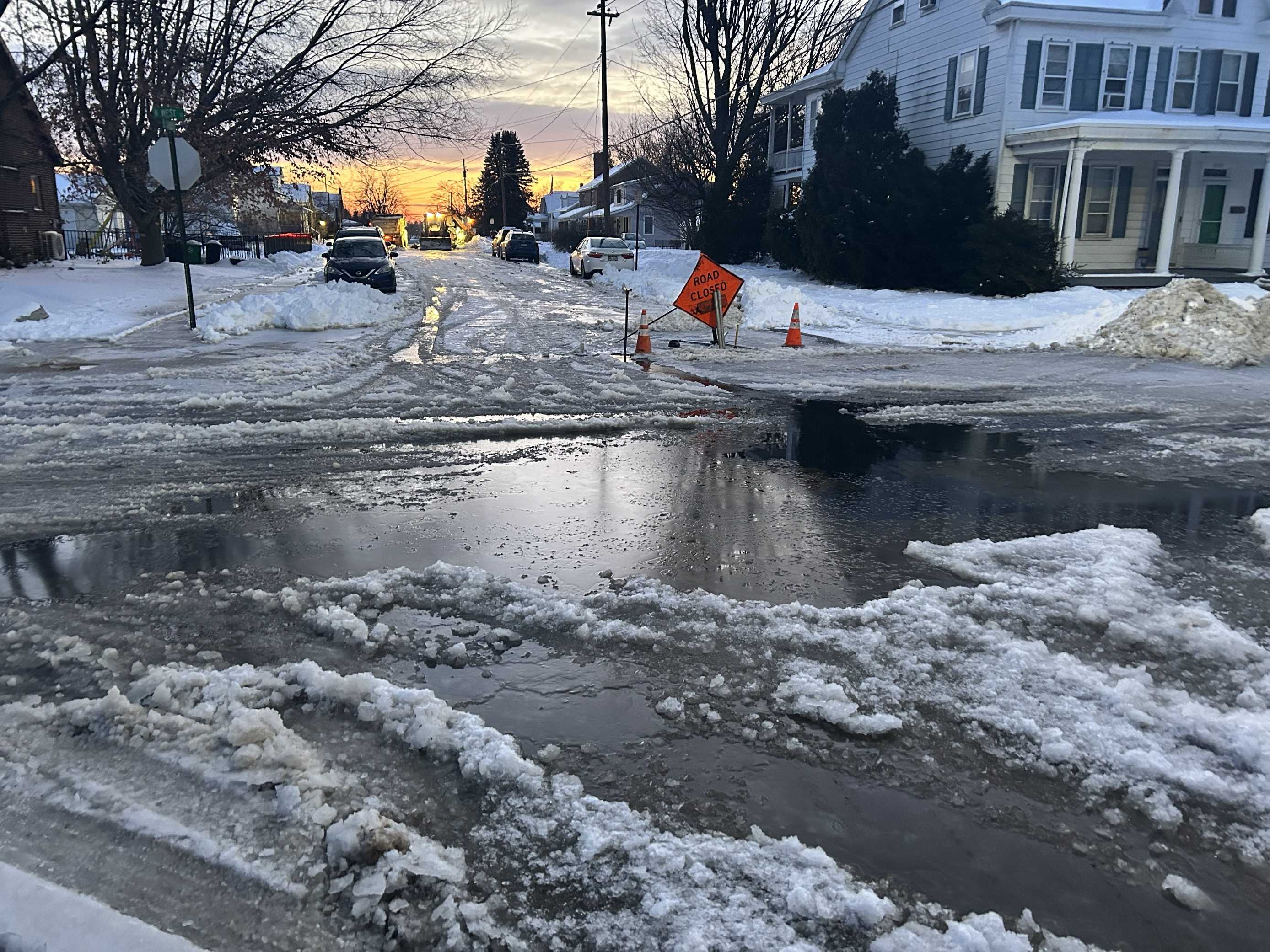 Water main break floods roads, trapping vehicles in ice