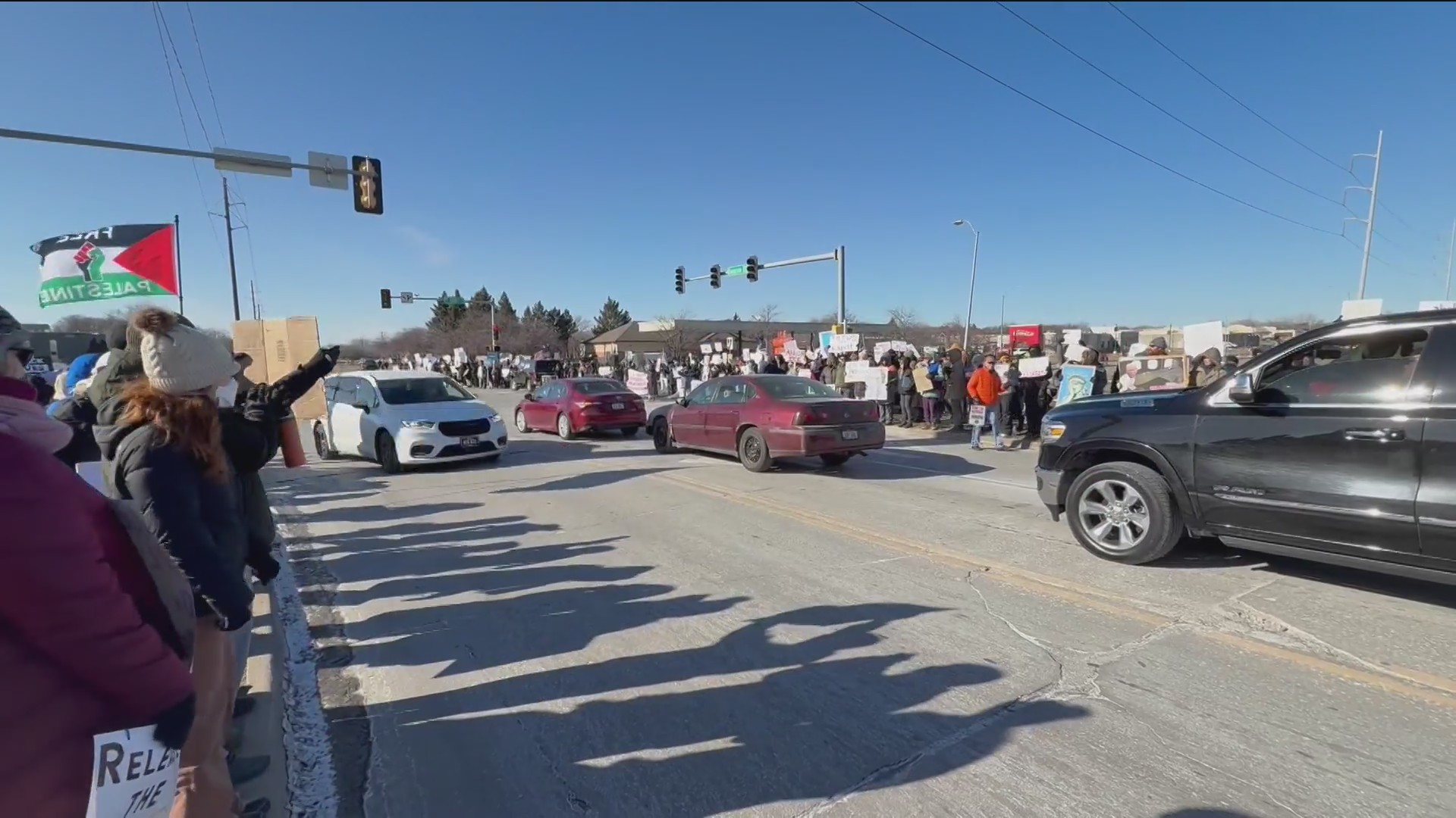 Large crowd of protesters gathered in Clive ahead of presidential visit