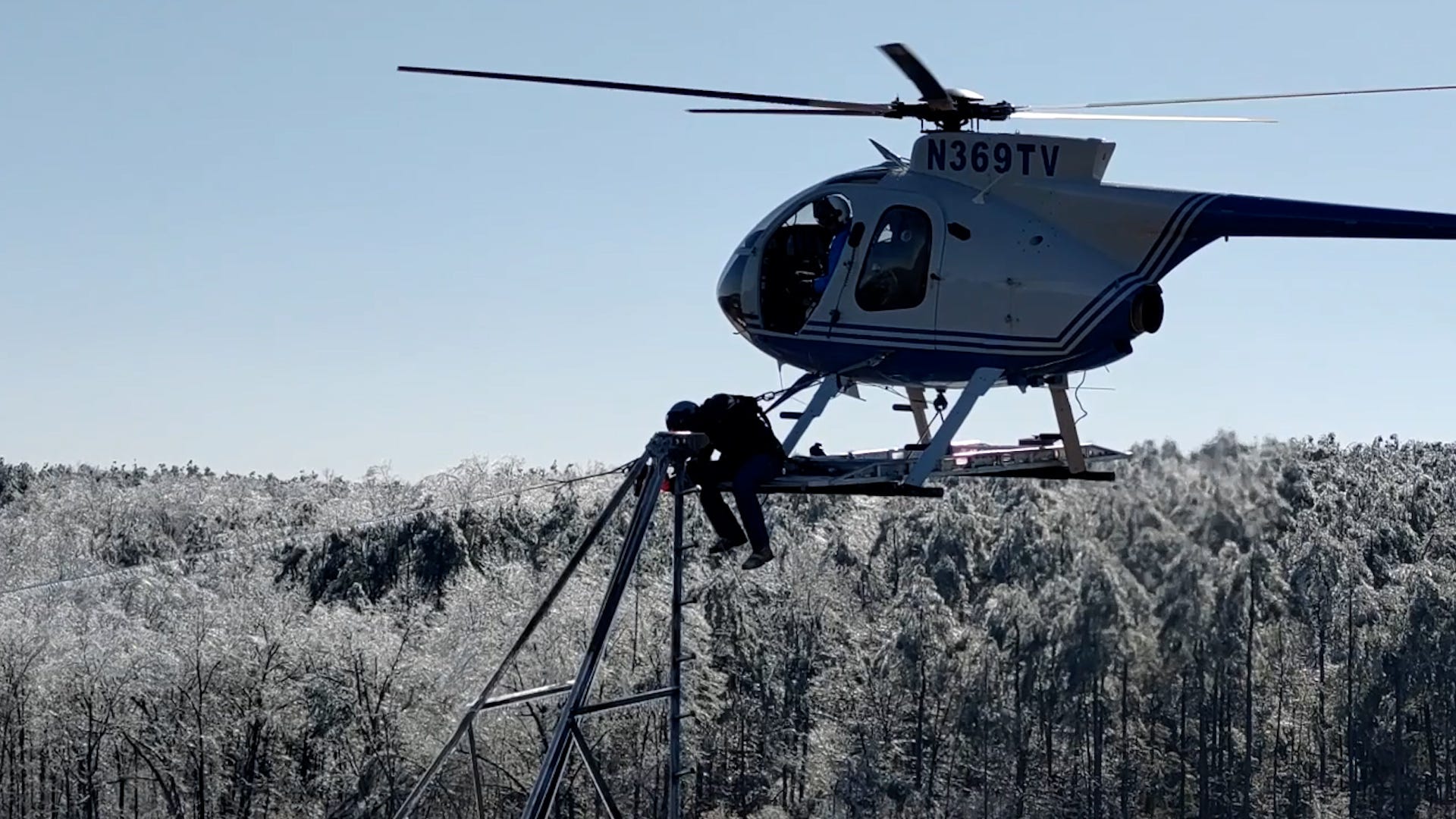 Watch daring linemen hang from helicopters to fix icy power lines in MS
