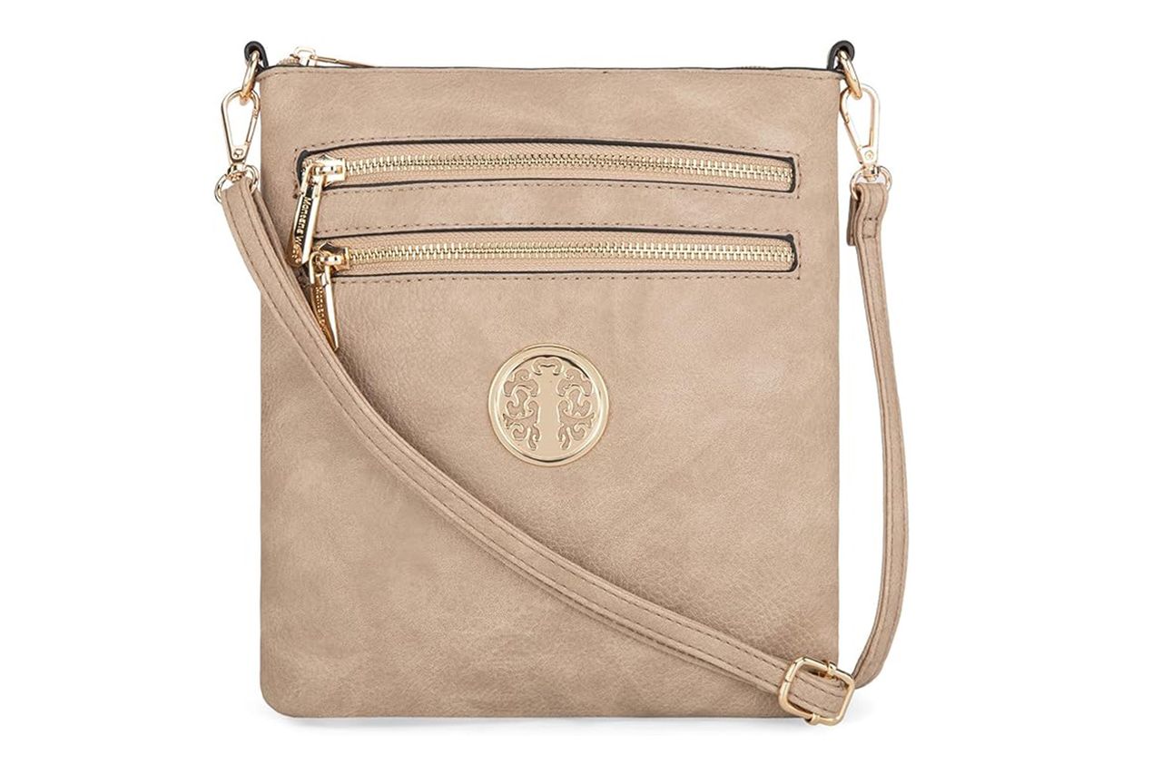 A beige crossbody bag with zip closures and a round logo design on the front