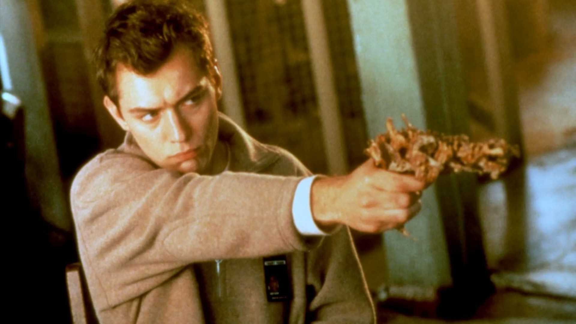 Jude Law points a strange gun in Existenz