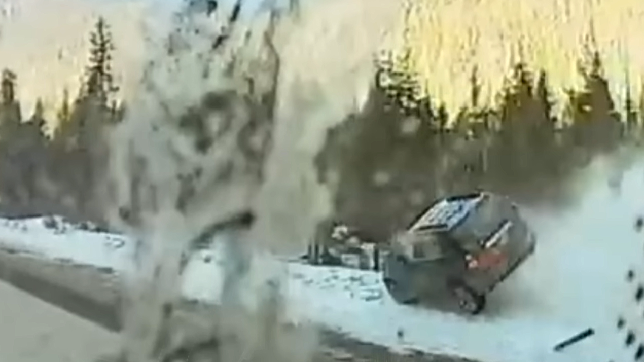 Out of control car slides along the snowy shoulder of I-70
