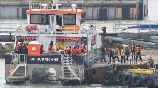 A group of people, thought to be migrants, disembark from a Border Force vessel in Ramsgate, Kent. Pic: PA