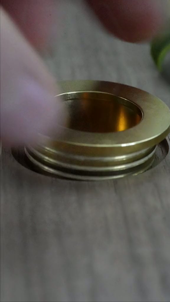 Brass pull installation in solid wood with a hidden cap