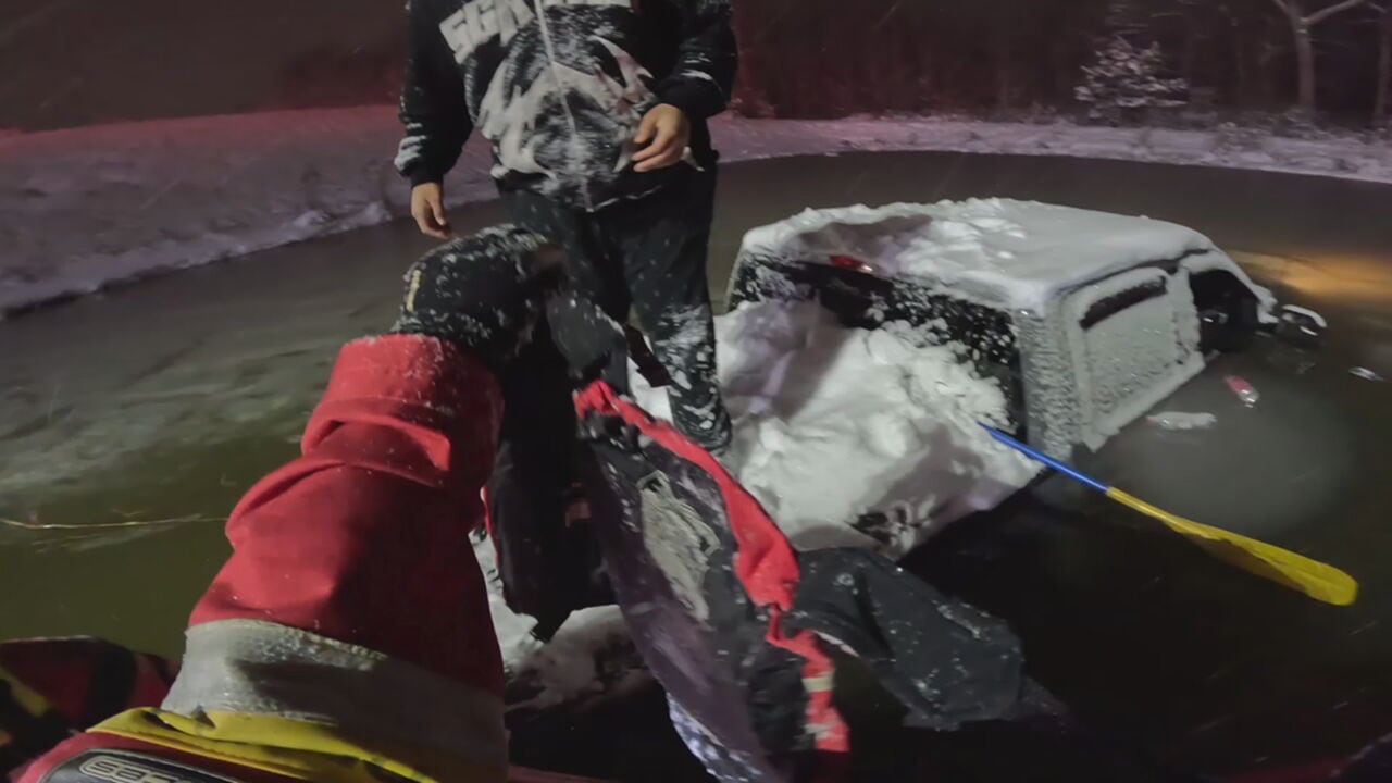 Heroic firefighter saves driver from sinking pickup truck in icy pond