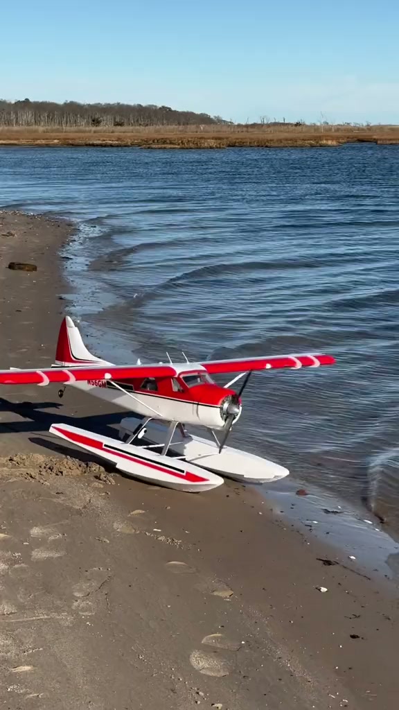RC seaplane taxis off the beach and lifts from the bay