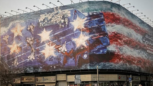 FILE: A billboard depicting a damaged US aircraft carrier with disabled fighter jets on its deck is seen at Islamic Revolution Square in Tehran, 25 January 2026