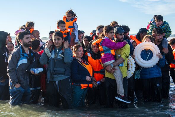 Migrants standing in shallow water in Channel