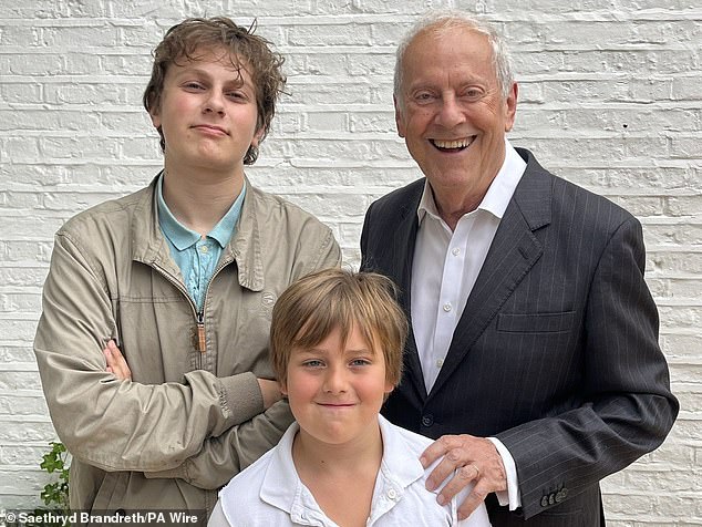 Kitt (centre) has been in remission for eight years and has yearly checks at GOSH (pictured with Gyles and his older brother Rory, left) 