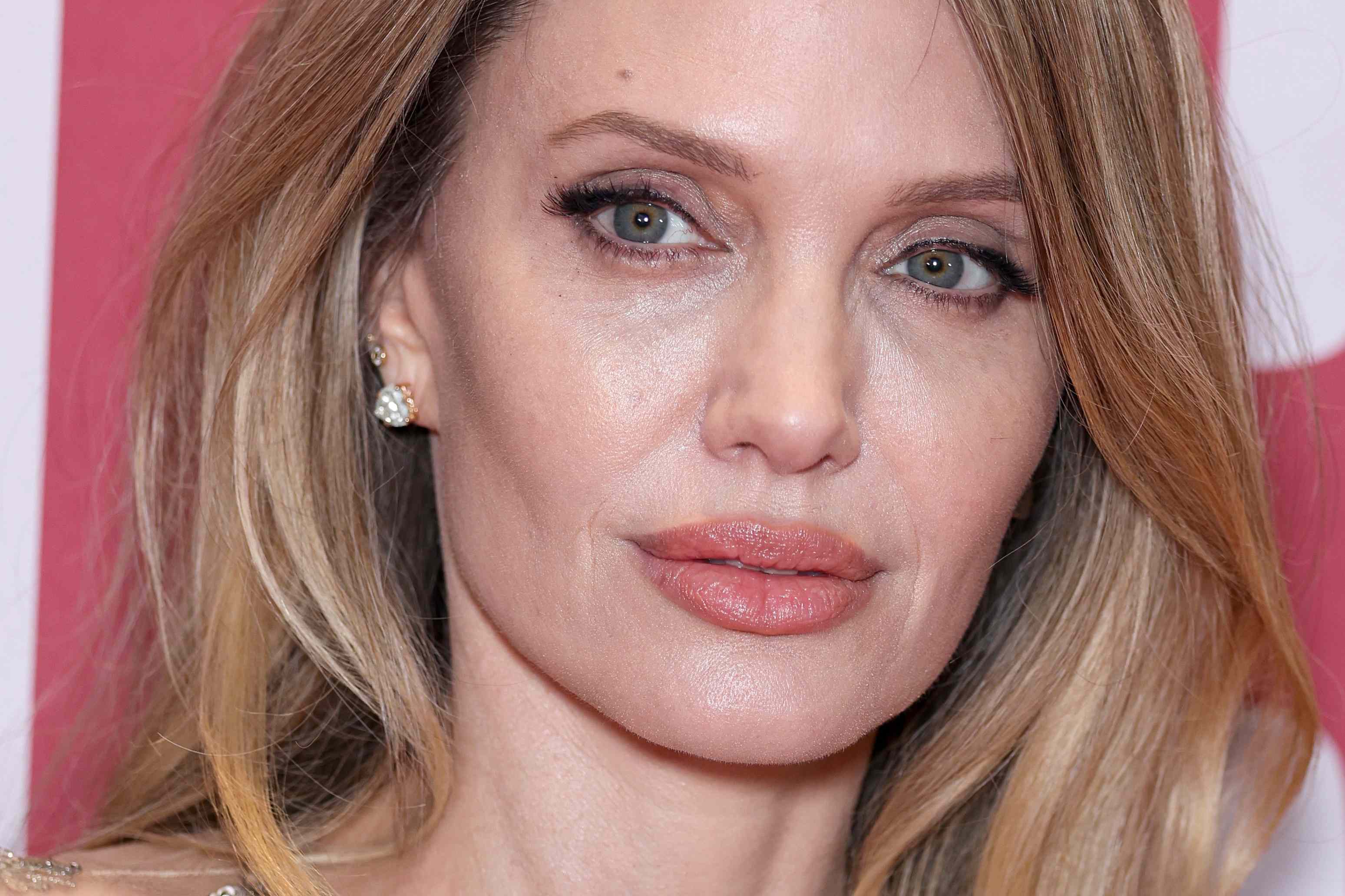 Angelina Jolie's sheer sequined dress looks like it's literally dripping in  gold
