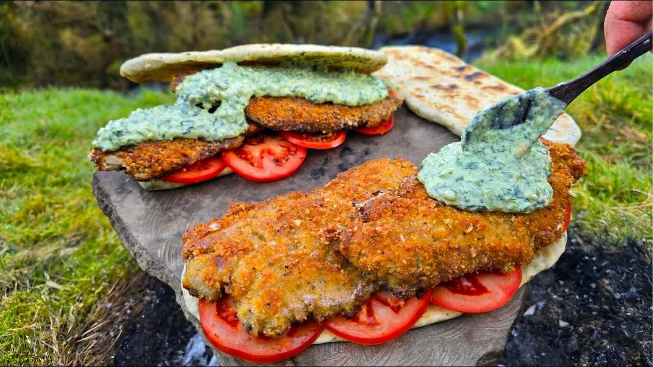 Crispy schnitzel pesto sandwich cooked on volcanic stone