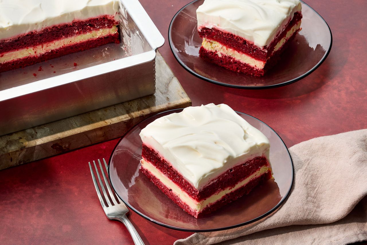 Southern Love Cake sliced on plates to serve on a red surface