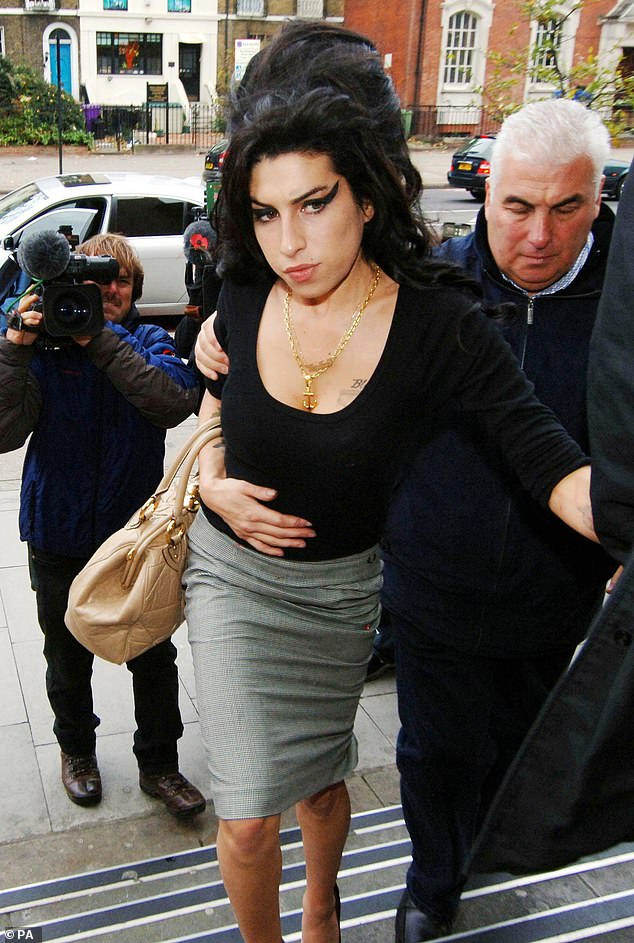 Winehouse arrives with her father Mitch at Thames Magistrates Court to see Fielder-Civil appear on charges of perverting the course of justice, 2007 
