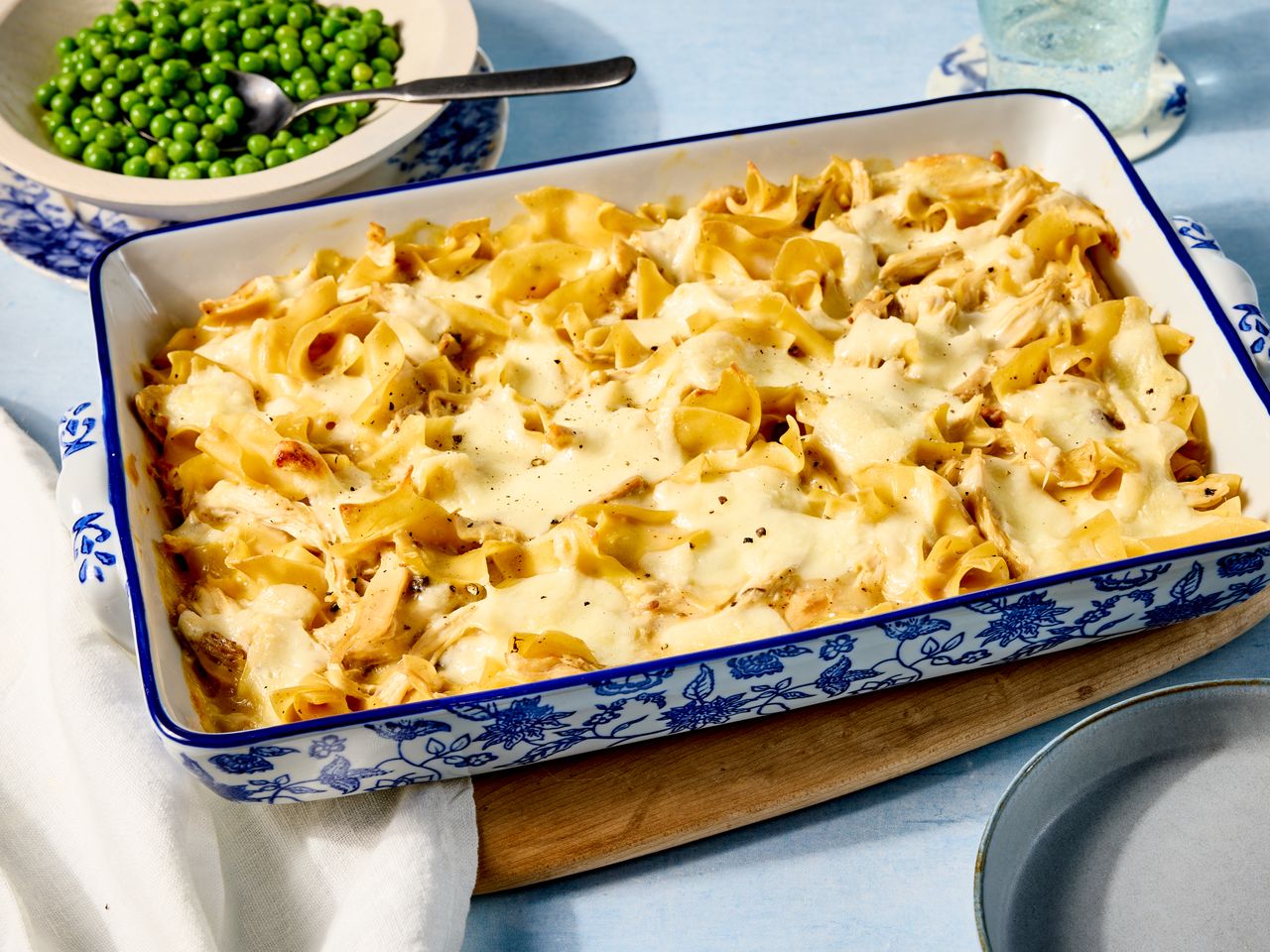 chicken noodle casserole resting on a wooden board, ready to be served.