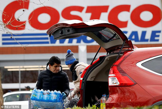 A shopper packs a car with purchases outside Costco, whose focus on large, high-volume items reduces the risk of unpaid goods leaving the store 