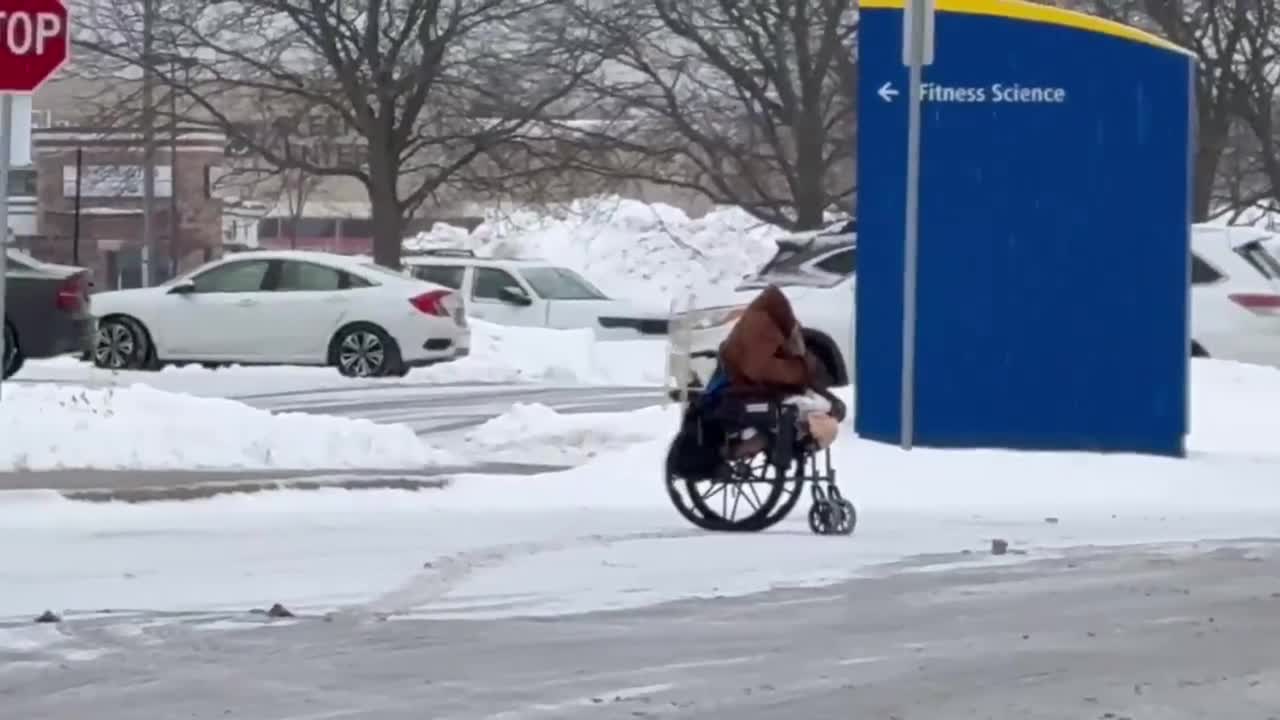 Elderly disabled woman in wheelchair left stranded in the rain in New York