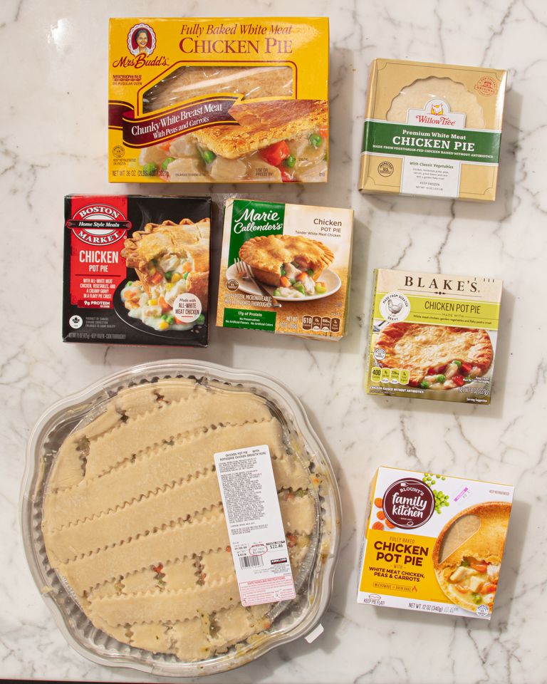 Assorted frozen chicken pot pie packaging arranged on a marble surface