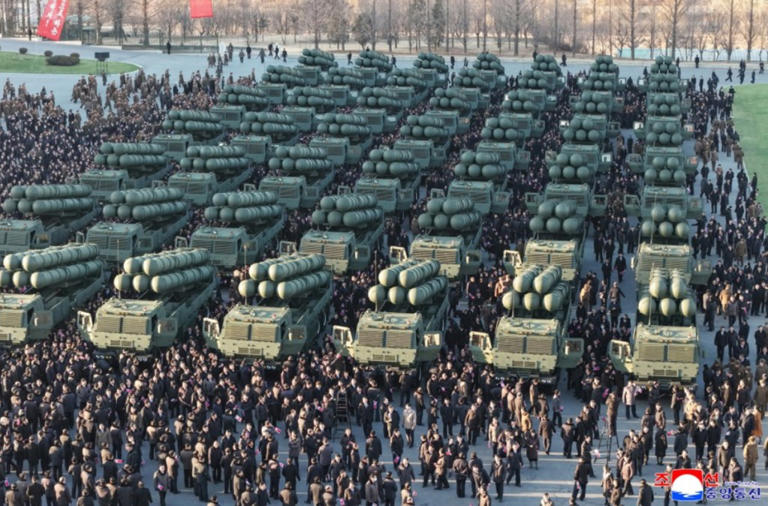 New photos show North Korea leader showing off nuclear-capable missiles