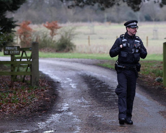 A police officer stands at the entrance to the Wood Farm on the Sandringham estate, reported to be interim accommodation for Mountbatten-Windsor. Photograph: Chris Radburn/Reuters