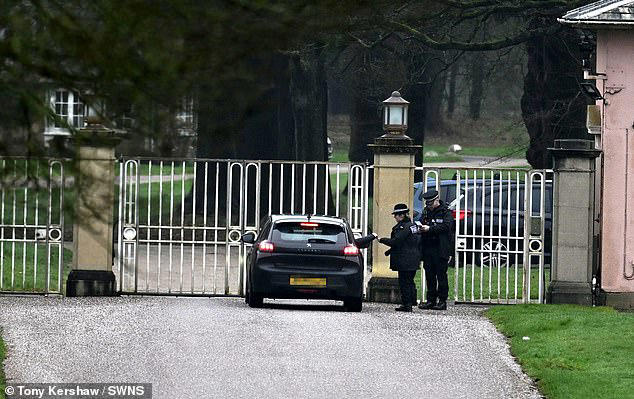 Windsor: Police officers are seen at the gates of Andrew's former home in Berkshire, Royal Lodge