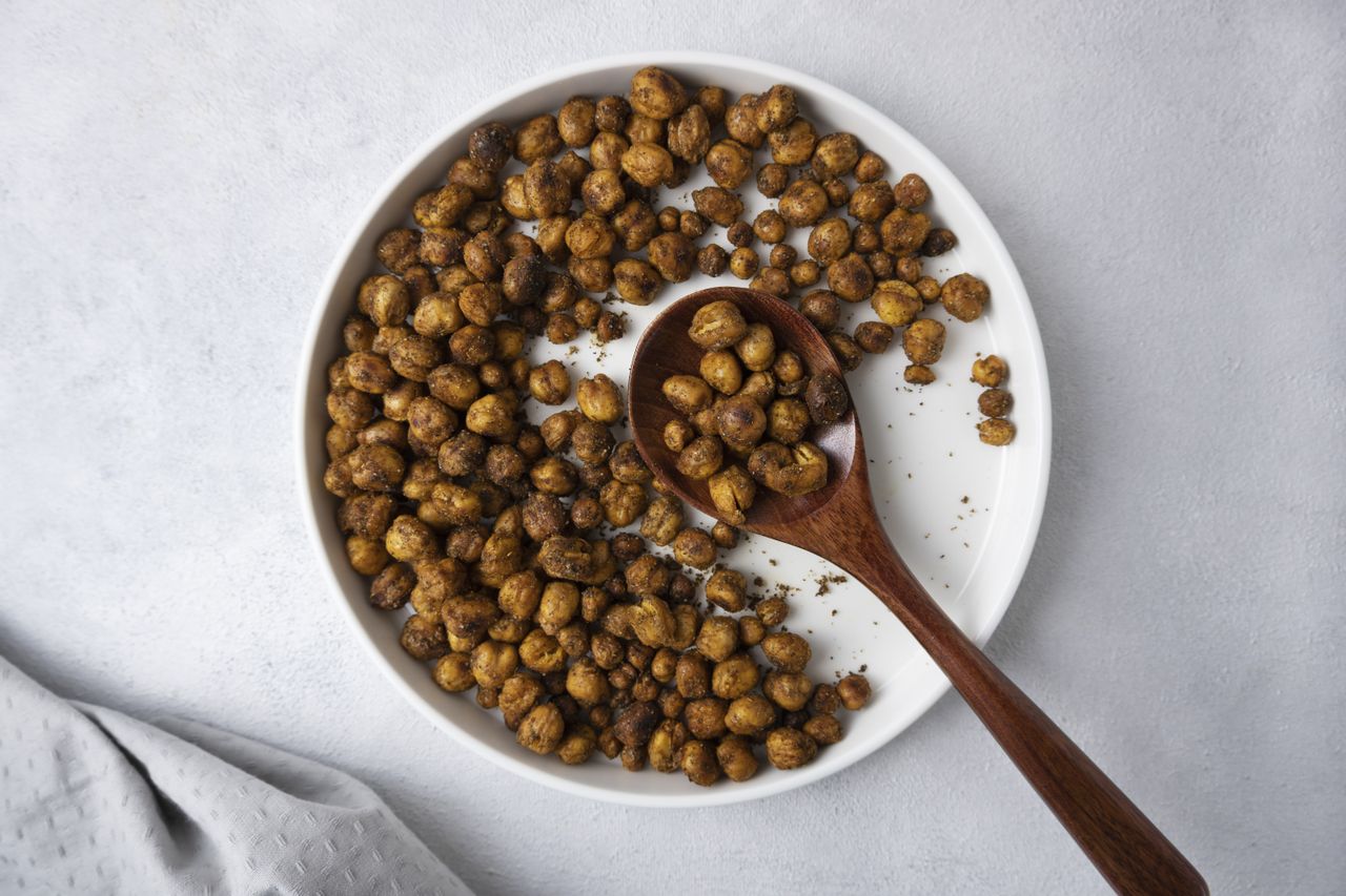 Roasted and seasoned chickpeas on a white serving plate