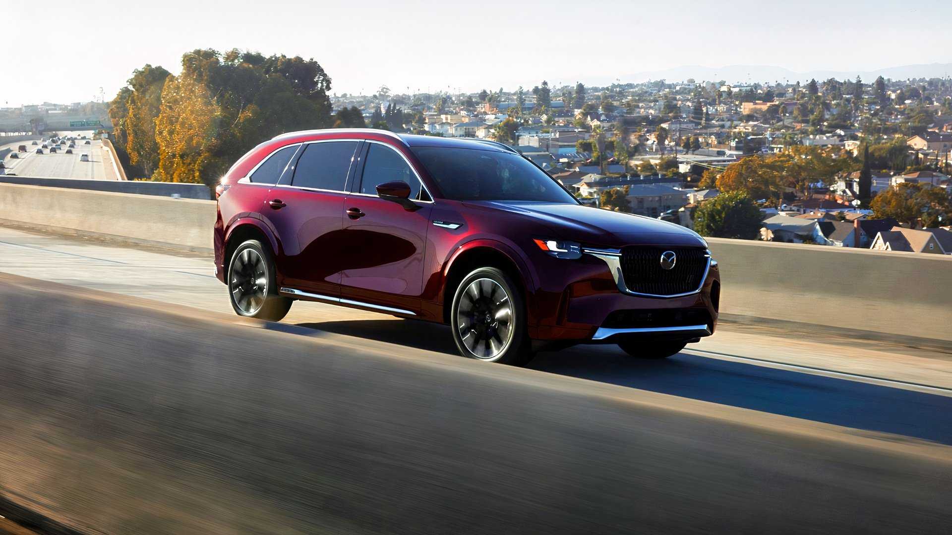 2026 Mazda CX-90 driving front 3/4 view