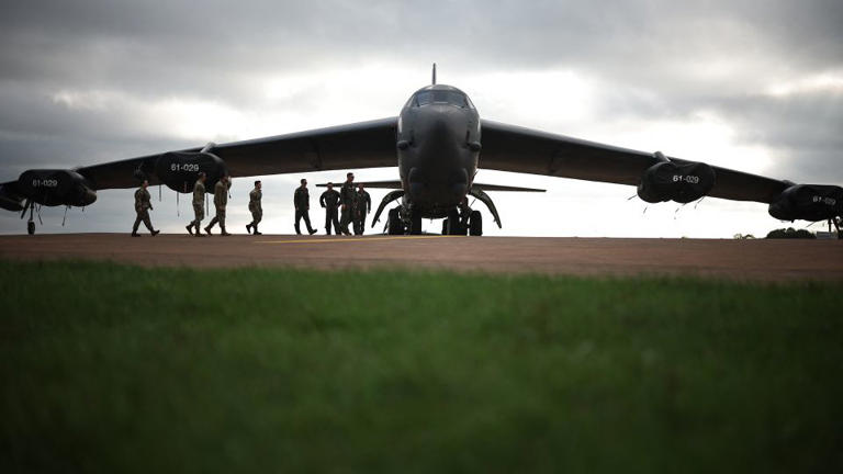 Flight crew from US Air Force 501st Combat Support Wing and 307th Bomb Wing walk toward a B-52 Stratofortress bomber aircraft at RAF Fairford on September 19, 2025. - Henry Nicholls/AFP/Getty Images/File
