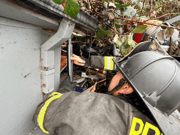 Person trapped, struggling to breathe after large tree crashes into a home