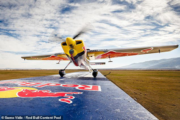 Watch the moment a pilot lands a plane on a train travelling at 75mph ...