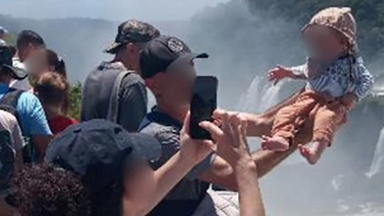 Tourist dangles baby over edge of 260ft waterfall for a holiday snap