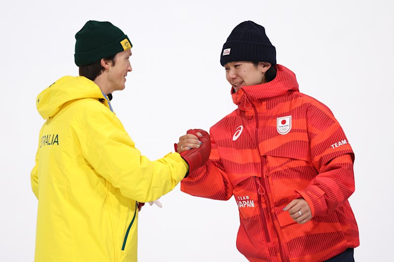 Scotty James congratulates Yuto Totsuka, the Japanese gold medalist in men’s halfpipe.