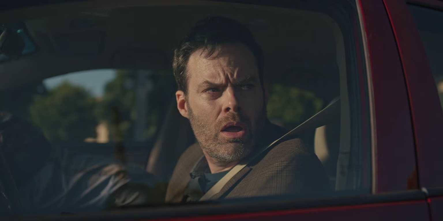 Bill Hader looking confused in a crashed car in Barry