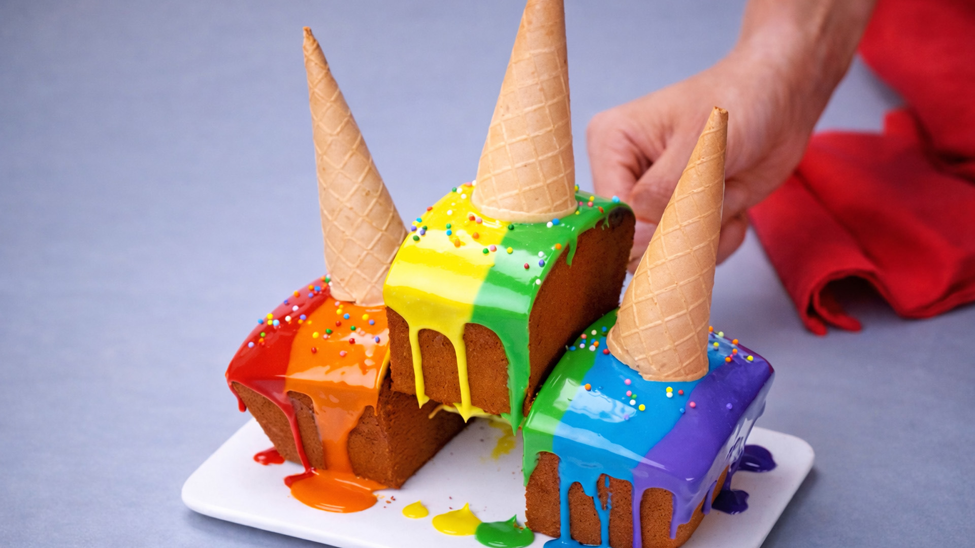 Rainbow drip cake with upside down cones