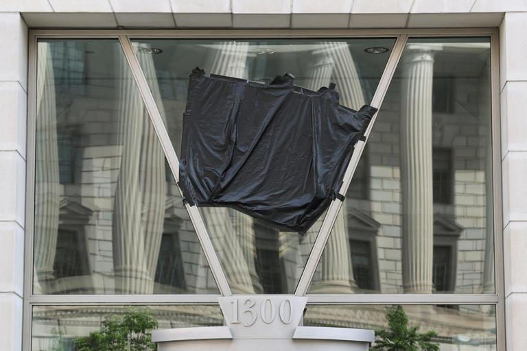 A black plastic shroud covers the signage on the windows of the former offices of the U.S. Agency for International Development (USAID) at the Ronald Reagan Building and International Trade Center in Washington, D.C., U.S., April 24, 2025. REUTERS/Jonathan Ernst