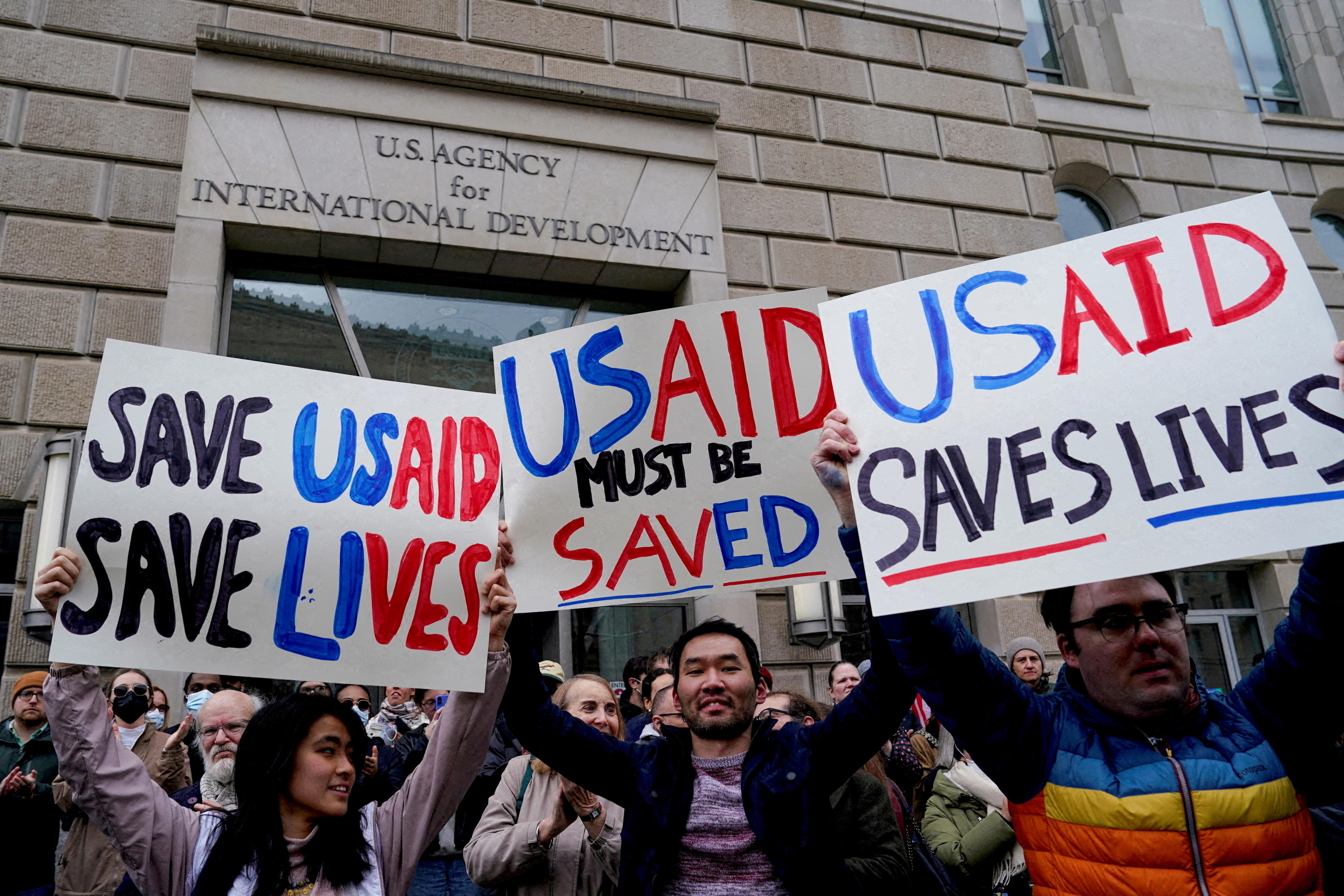 On Feb. 3, 2025, demonstrators showing support for USAID hold signs outside its building in Washington, D.C. after it was closed to employees.