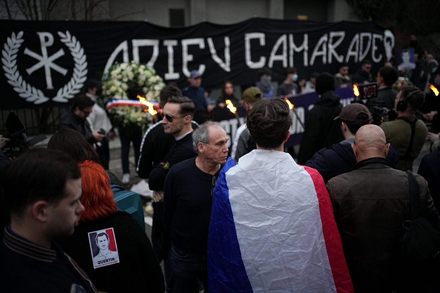 People hold a banner reading 'Goodbye mate' as they take part in a march in Lyon, France, Saturday, Feb. 21, 2026, to pay tribute to Quentin Deranque, a 23-year-old nationalist activist who died from a beating after a clash between far-left and far-right supporters. (AP Photo/Laurent Cipriani)