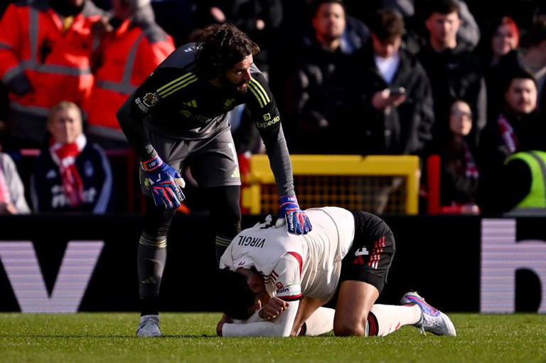 NOTTINGHAM, ENGLAND - FEBRUARY 22: (THE SUN OUT, THE SUN ON SUNDAY OUT) Virgil van Dijk of Liverpool reacts on the floor, as his teammate Alisson Becker looks on during the Premier League match between Nottingham Forest and Liverpool at City Ground on February 22, 2026 in Nottingham, England. (Photo by Liverpool FC/Liverpool FC via Getty Images)