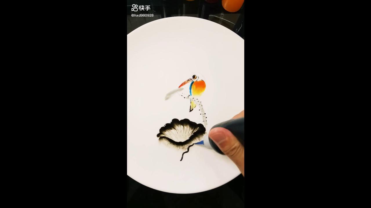 The art of painting a vibrant orange and blue koi fish on white ceramic ...