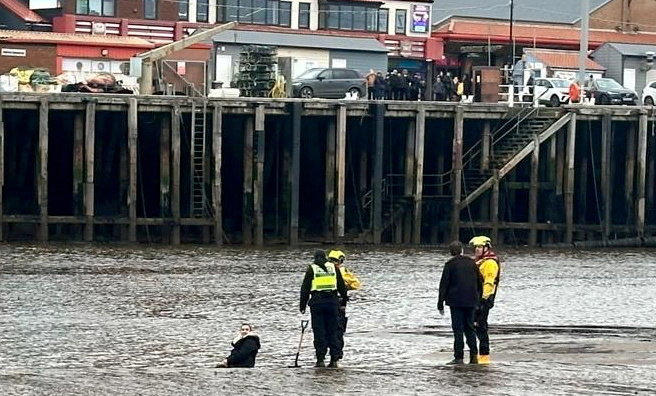 Mum rescued after getting stuck in knee-deep mud while helping daughter