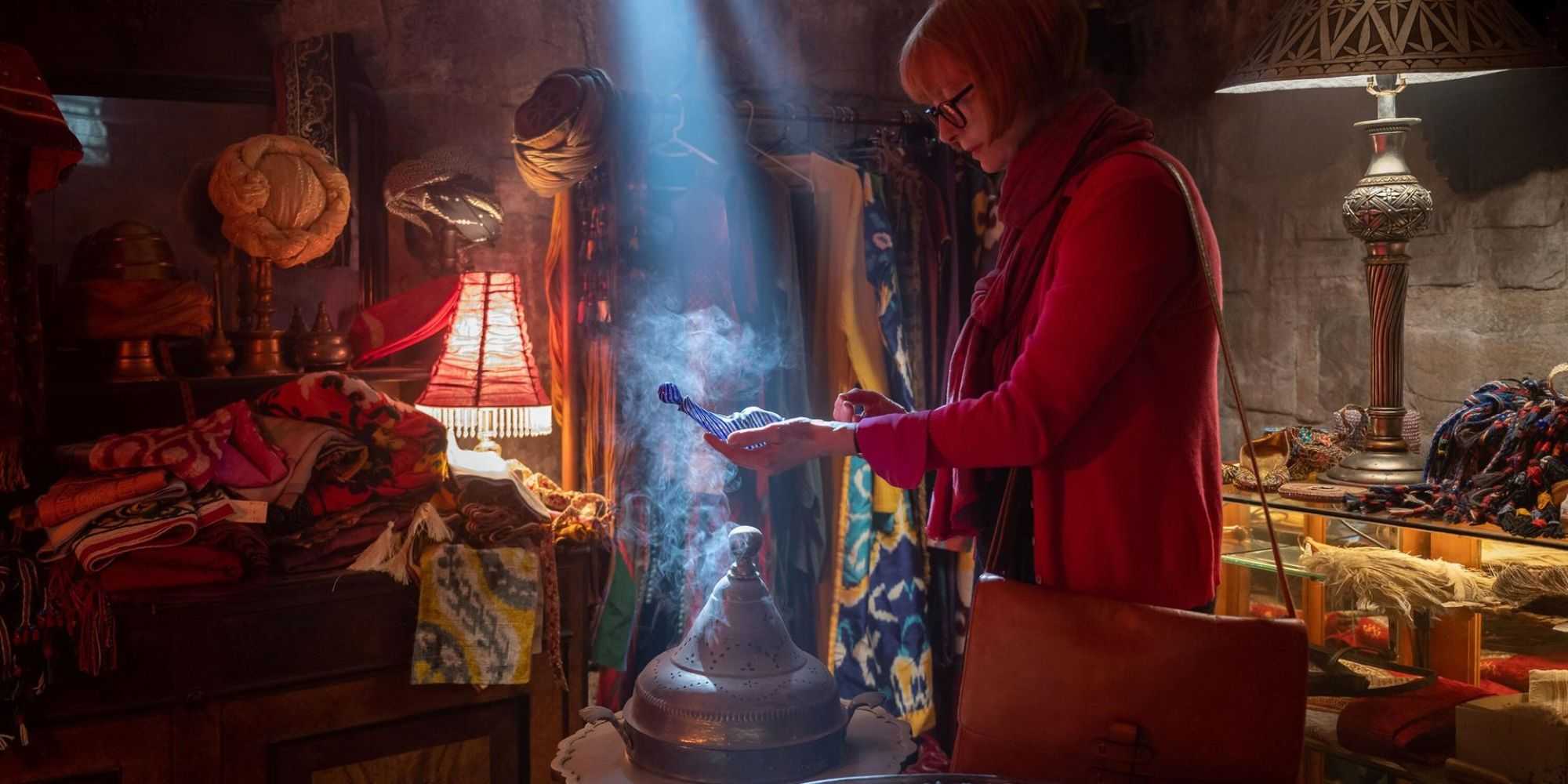 Tilda Swinton as Alithea Binnie examines a djinn bottle in a shop in Three Thousand Years of Longing